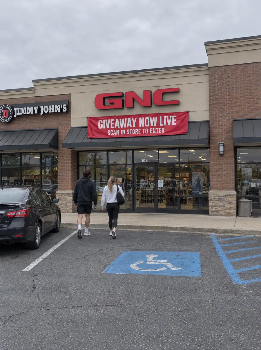 GNC storefront with giveaway window signage